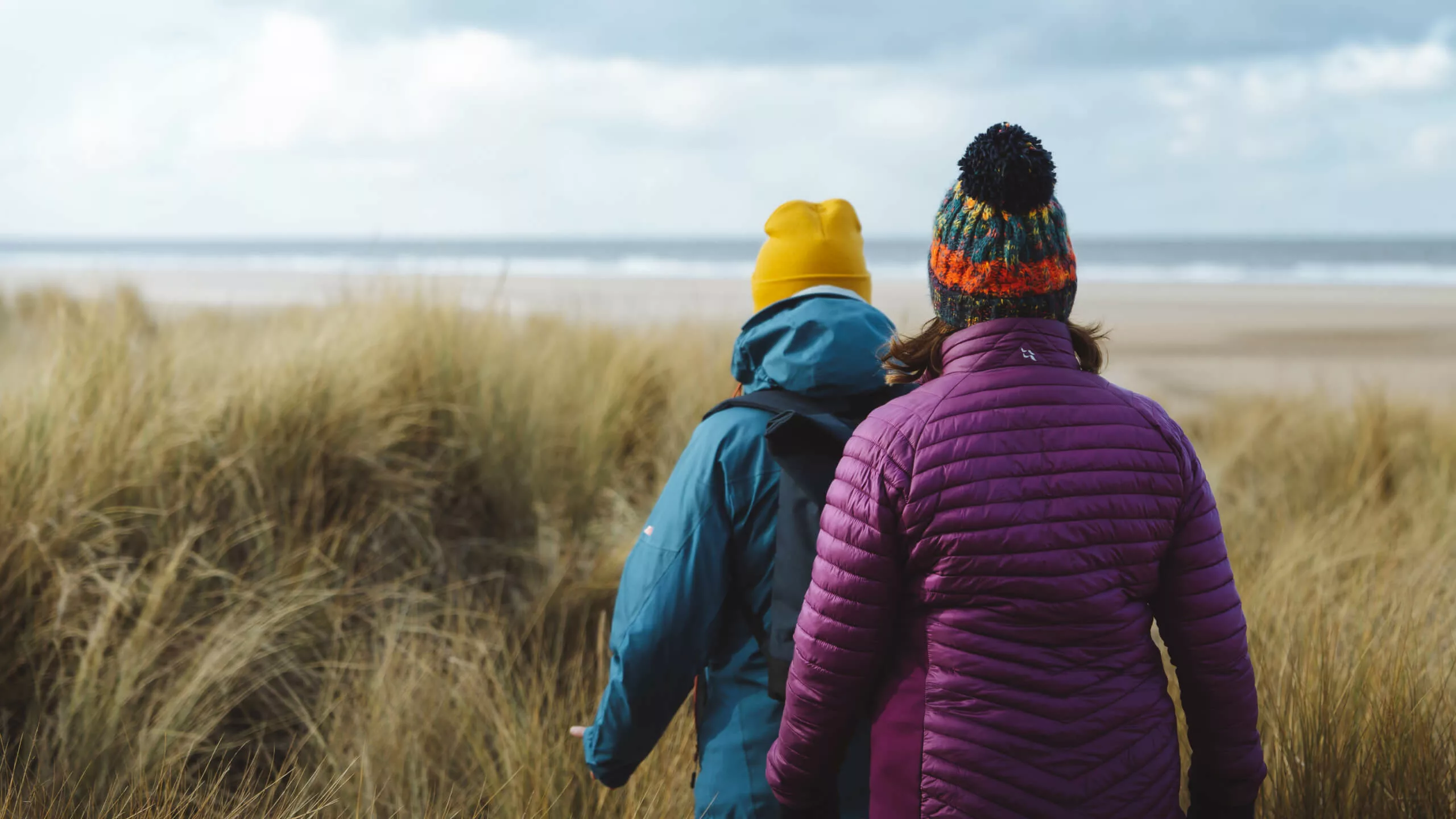 Two people walking on Holkham beach