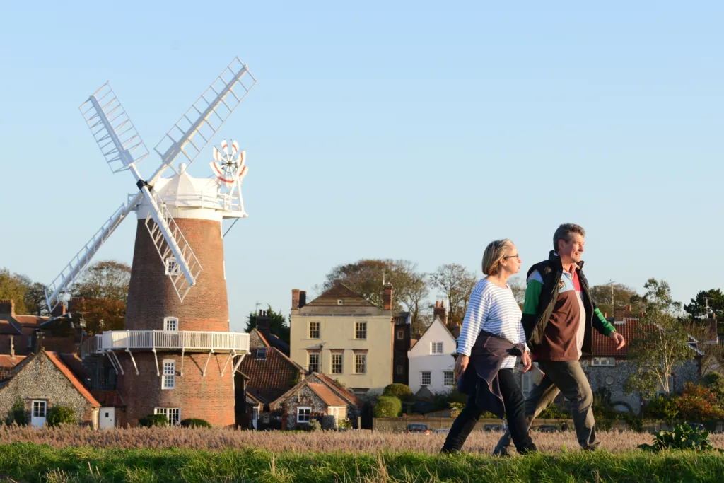 A couple talking past Cley windmill