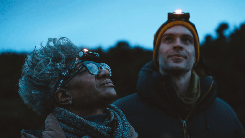 A woman and man starring up at the night sky.
